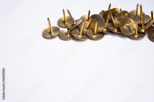 golden pins. stationery concept. copy space. isolated. High quality photo