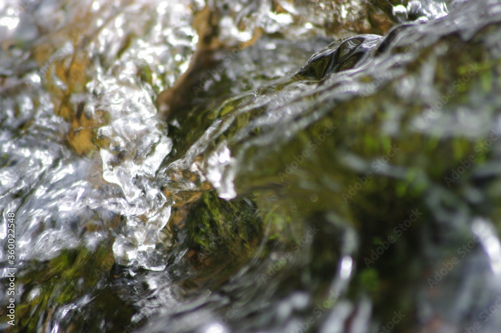 Crystal splashes of water, playful foam in the streams of the river. Stones under the streams of a swift, mountain river... Crystal splashes of water, playful foam in the streams of the river. Stones under the streams of a swift, mountain river...