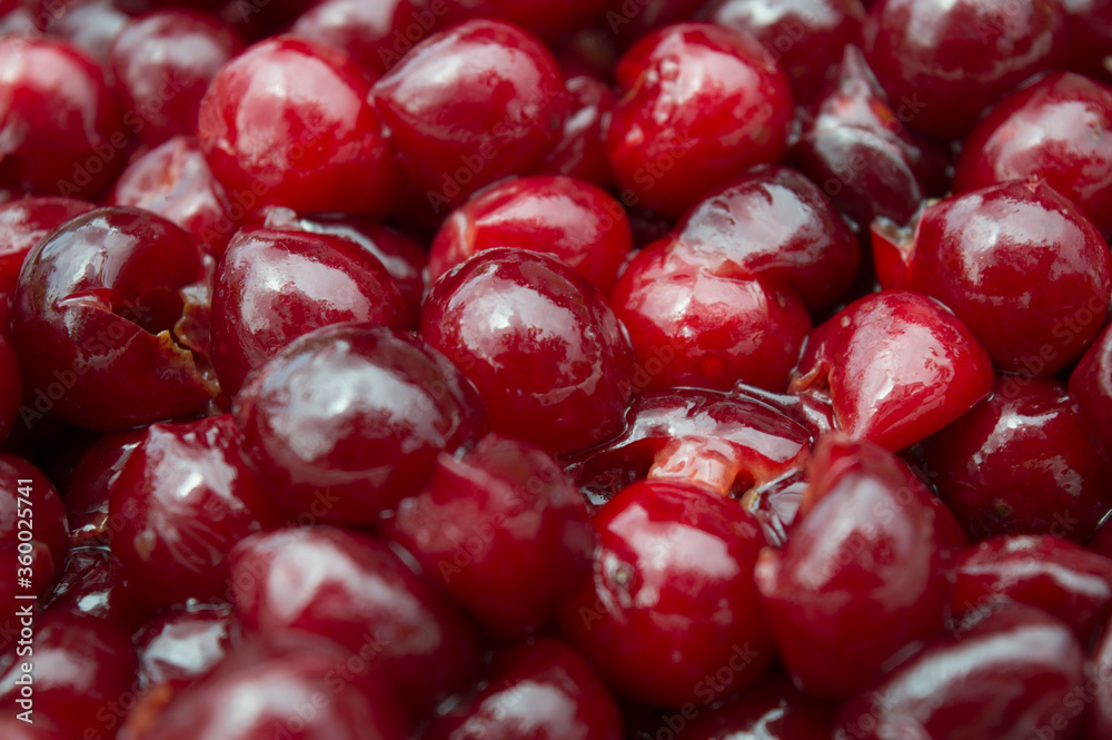 Red juicy cherry berries in sugar syrup. Pitted fruits. Making jam, canning products at home. Food. Close-up. Background, selective focus Red juicy cherry berries in sugar syrup. Pitted fruits. Making jam, canning products at home. Food. Close-up. Background, selective focus