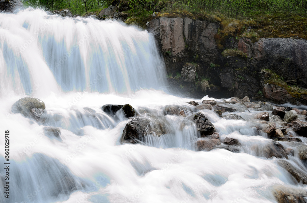 beautiful waterfall flowing over rocks and stones