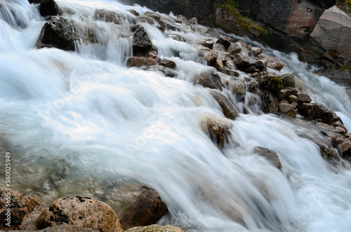 beautiful waterfall flowing over rocks and stones © Arcticphotoworks