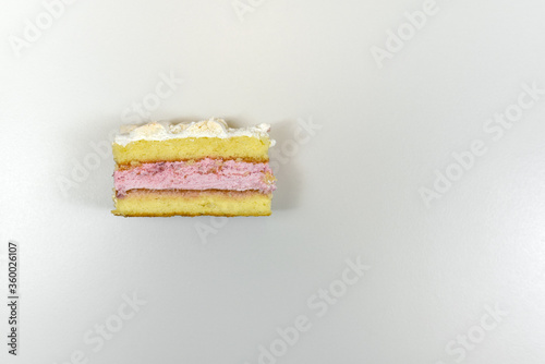 top view of a piece of homemade cake on a white table