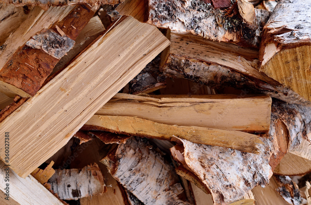 Pile of dry birch logs for fireplace