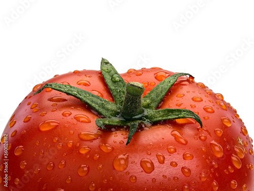 Large fragment of ripe tomato covered with water drops