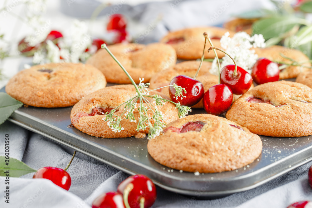 Homemade baking. Cupcakes with cherries.Dessert decorates with fresh berries and leaves. Wooden background. Food styling Homemade baking. Cupcakes with cherries.Dessert decorates with fresh berries and leaves. Wooden background. Food styling