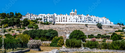 A view across farmland to the settlement of Locorontondo, Puglia, Italy in the summertime