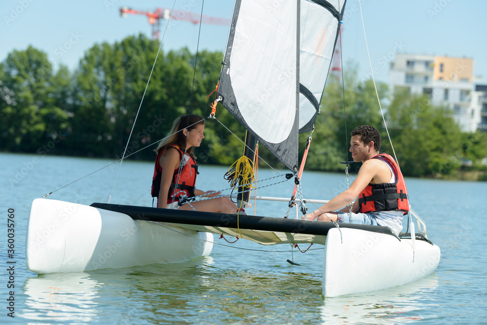 Naklejka premium couple sailing in the lake