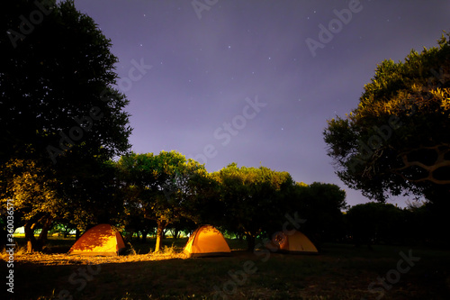 Traveling and camping concept .  camp tent at night under a sky full of stars.