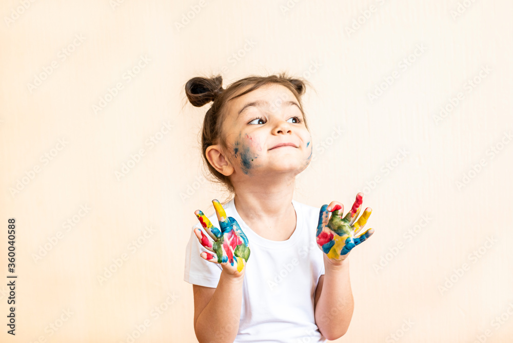 joyful little girl with painted hands. the child joyfully shows his palms painted with paints. painted children's palms
joyful little girl with painted hands. the child joyfully shows his palms painted with paints. painted children's palms