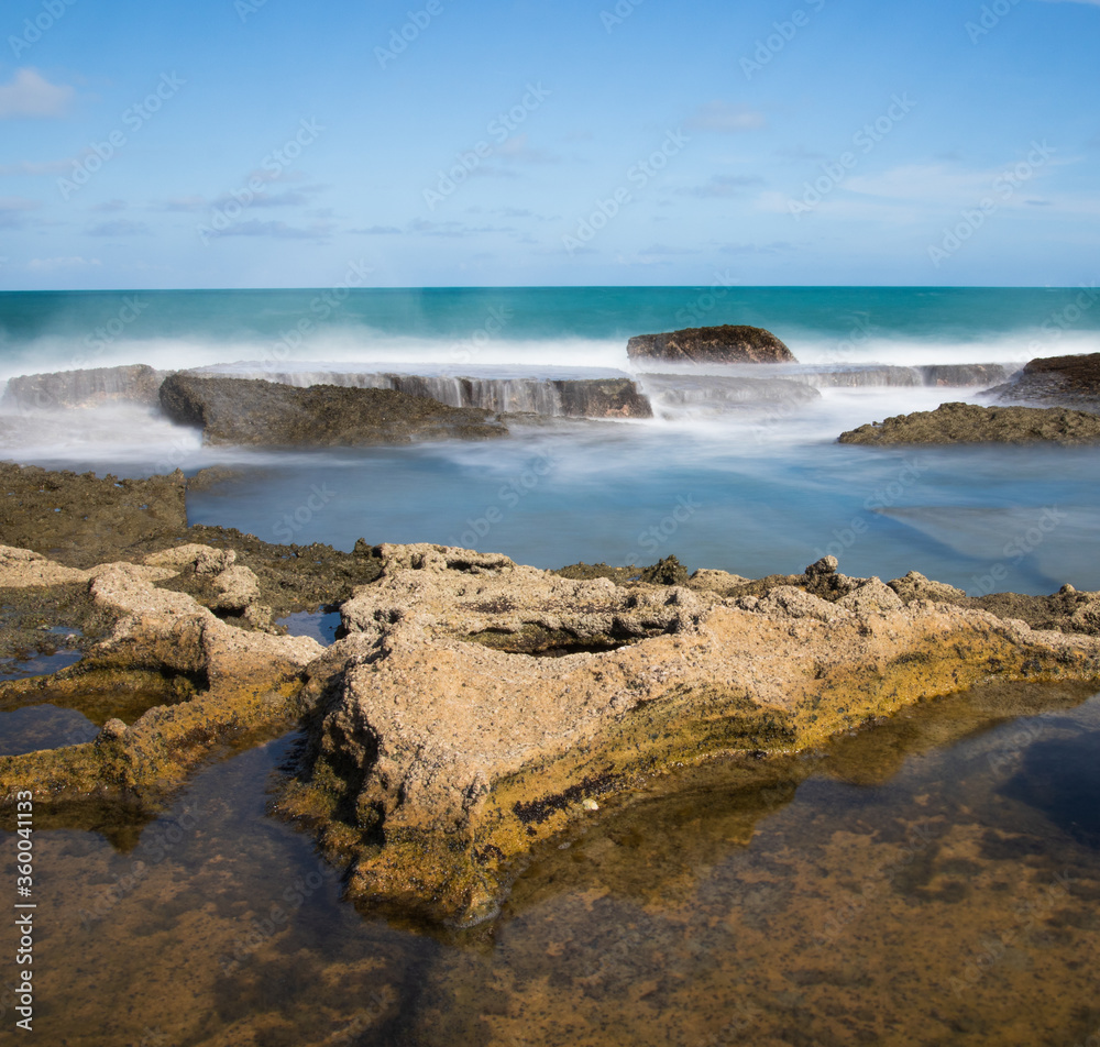 waves crashing on rocks - long exposure waves crashing on rocks - long exposure