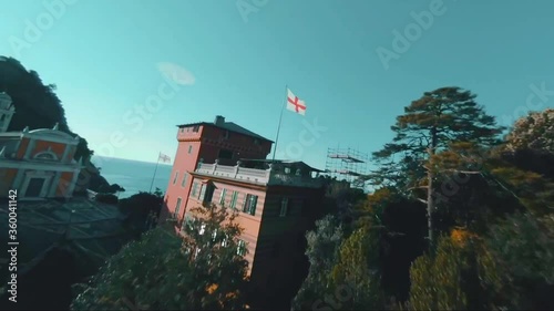 Aerial, FPV, drone shot around the San Giorgio church, on a sunny and foggy day, Liguria, Italy - teal and orange photo