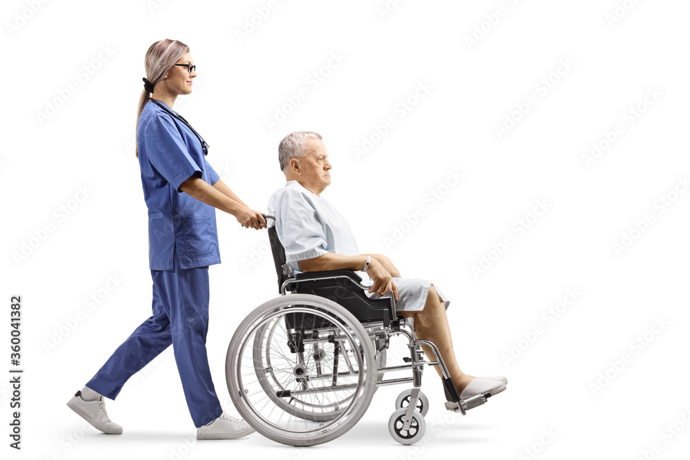 Nurse pushing a hospitalized mature patient in a wheelchair Nurse pushing a hospitalized mature patient in a wheelchair