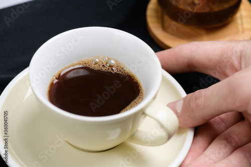 fresh coffee in the cup holding the hand