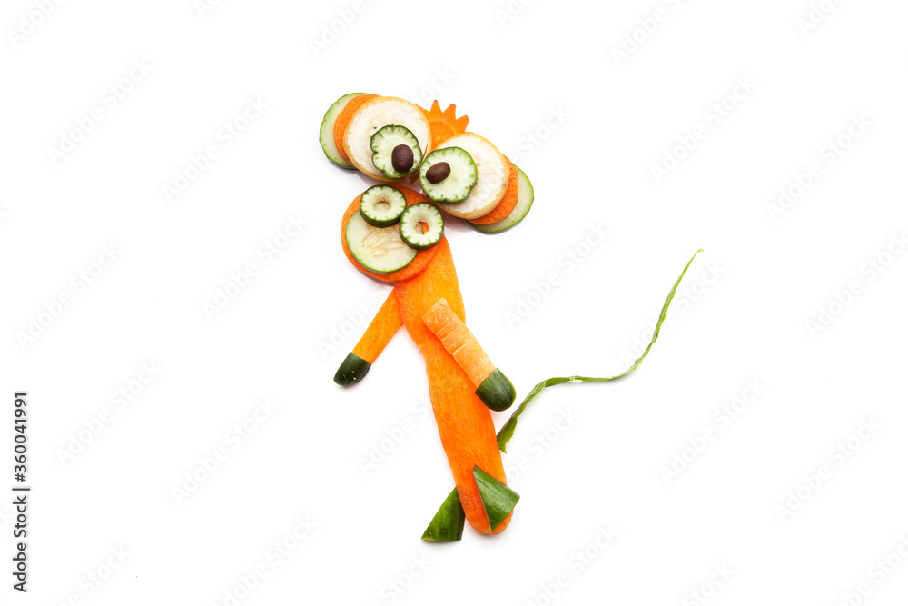 Food art creative concepts. Funny monkey made of fruits and vegetables such as cucumber, banana and carrots isolated over white background.
