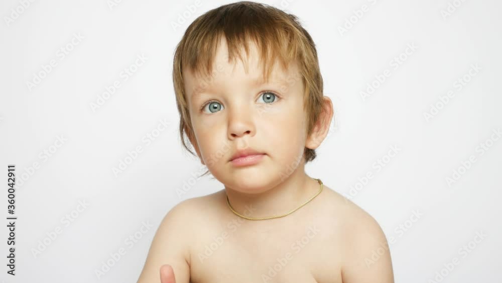 A portrait of a beautiful little boy against white background A portrait of a beautiful little boy against white background