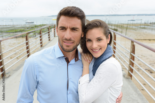 portrait of couple on coastal promenade © auremar