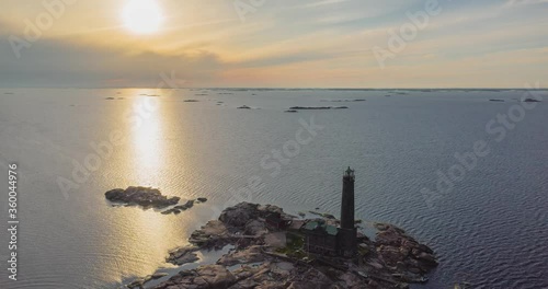 Scenic view of Bengtskär lighthouse during sunset. The lighthouse is the tallest lighthouse in the Nordic countries and is built on a beautiful skerry located in the Baltic sea. photo