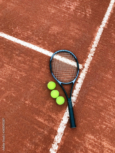 tennis racket and ball on court © Yan