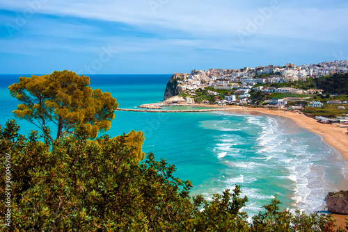 Panoramic view of the the famous old town of Peschici, carved into the rock. in front of the beautiful sea.Apulia.Italy