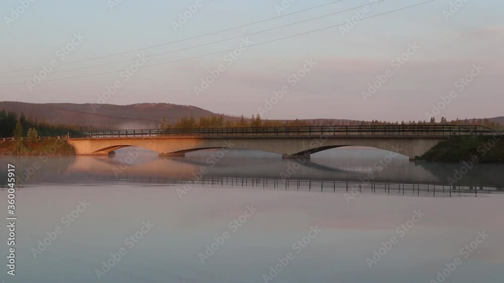 Morning Mist Above Lake Water and Bridge in Swedish Countryside Morning Mist Above Lake Water and Bridge in Swedish Countryside
