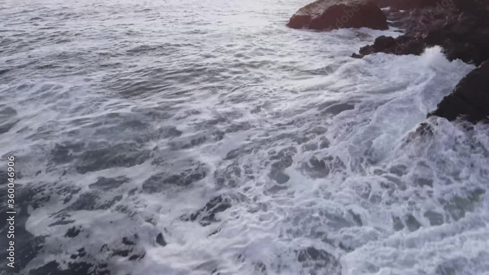 OCean waves crashing on cliff side OCean waves crashing on cliff side