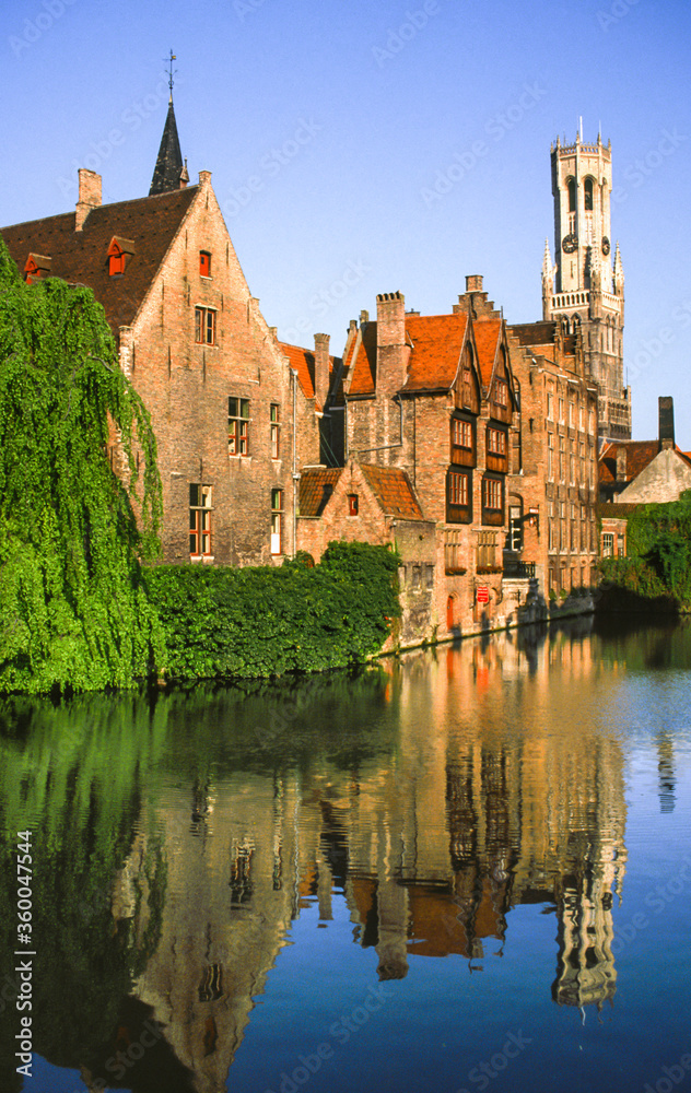 Reflection in a canal in Bruges, Belgium, of the Church of Our Lady.