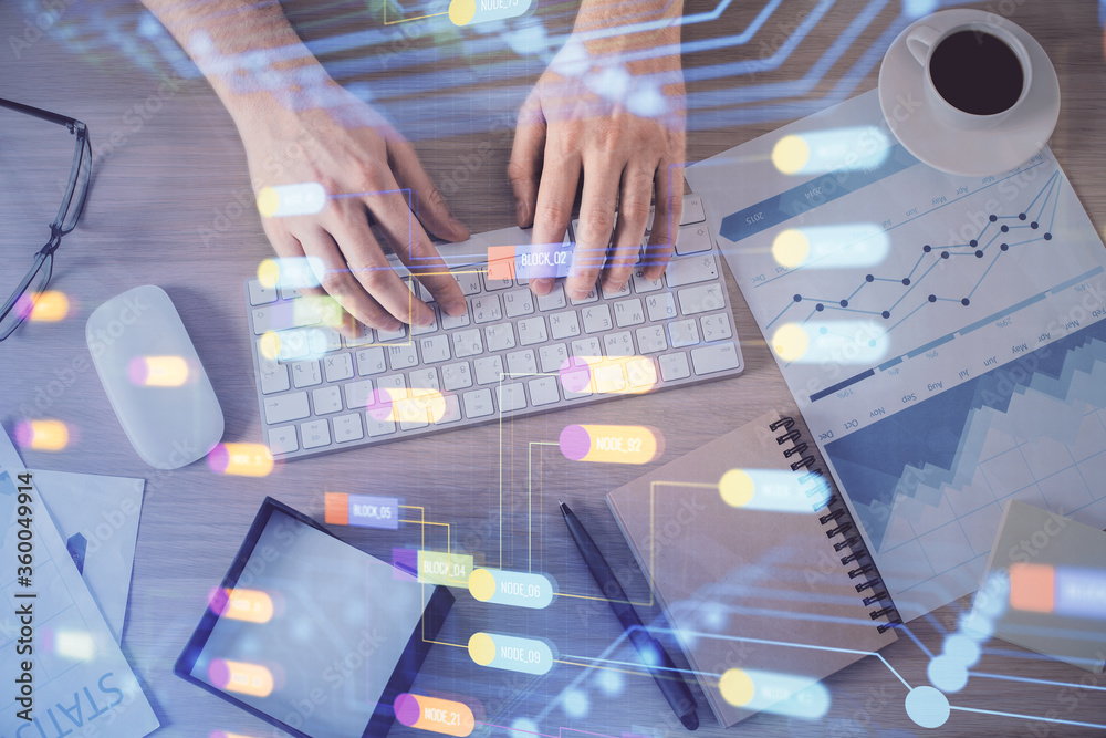Double exposure of man's hands typing over computer keyboard and data theme hologram drawing. Top view. Technology concept. Double exposure of man's hands typing over computer keyboard and data theme hologram drawing. Top view. Technology concept.