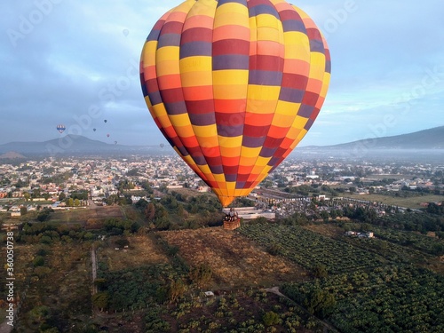 nice hot air balloon flying over a town