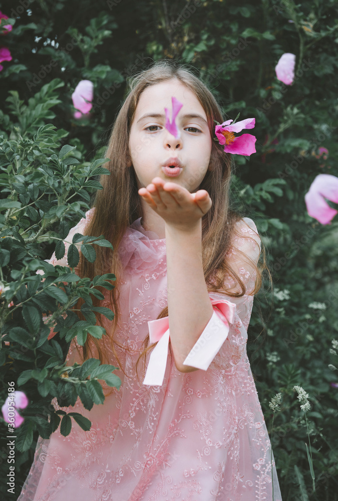 1 white girl 10 years old in a pink dress among the greenery with pink petals Stock Photo Adobe Stock
