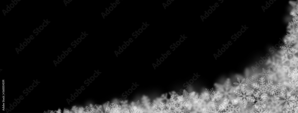 Christmas background of snowflakes of different shapes, sizes, blur and transparency on black background