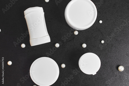 white cosmetic jars for bath pearl deodorant on a black table. Copyspace. mockup. top view. flat lay