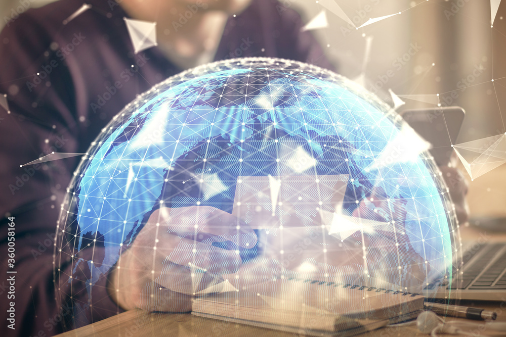 Double exposure of man's hands holding and using a phone and international business theme drawing. Double exposure of man's hands holding and using a phone and international business theme drawing.