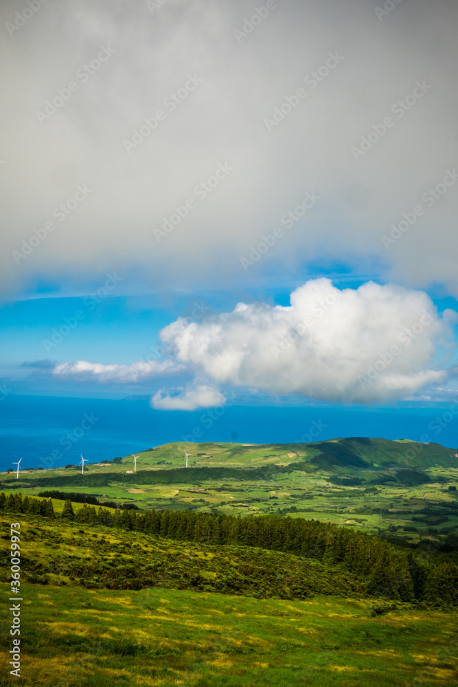 Beautiful green landscapes along the ocean in Faial island, Azores, Portugal and the view to Pico island and the mountain
