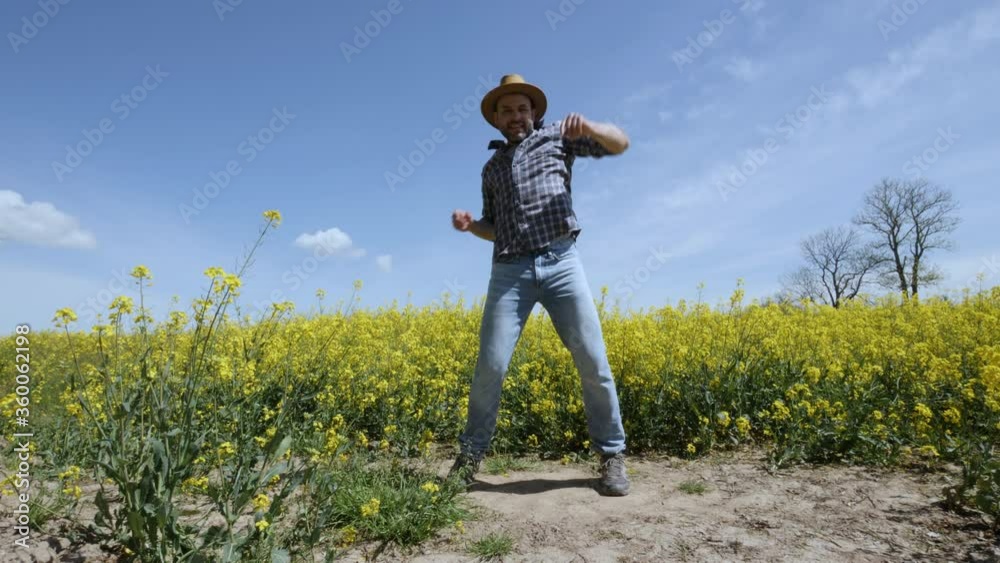 Happy Man Farmer Dancing Enjoying at Rape Blossom On Field. Fun Celebrating Funny Viral Dance Freedom. Guy Enjoying Dance. Joyful Man Farmer Dancing. Slow Motion. Flowering Rapeseed Field Blue Sky. Happy Man Farmer Dancing Enjoying at Rape Blossom On Field. Fun Celebrating Funny Viral Dance Freedom. Guy Enjoying Dance. Joyful Man Farmer Dancing. Slow Motion. Flowering Rapeseed Field Blue Sky.