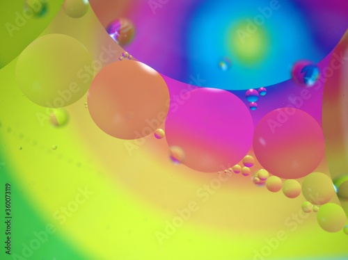 Closeup oil bubbles with colorful background and blurred ,macro image ,droplets sweet color ,rainbow and colorful balloons background, abstract background