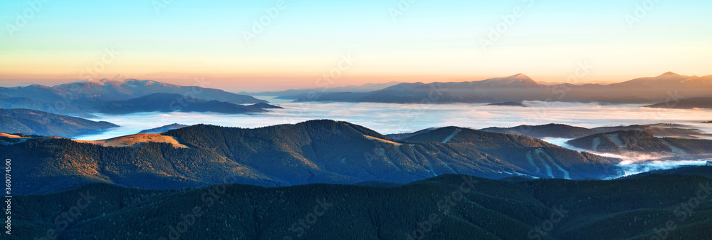 Beautiful dawn in the mountain range. Mountains shrouded in mist in a scenic landscape view. Location Carpathian mountains, Europe. Travel background