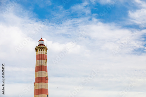 Praia da Barra lighthouse in Aveiro, Portugal. It is the highest lighthouse in Portugal with a height of 62 meters above the beach of the barrier and prone to Atlantic storms