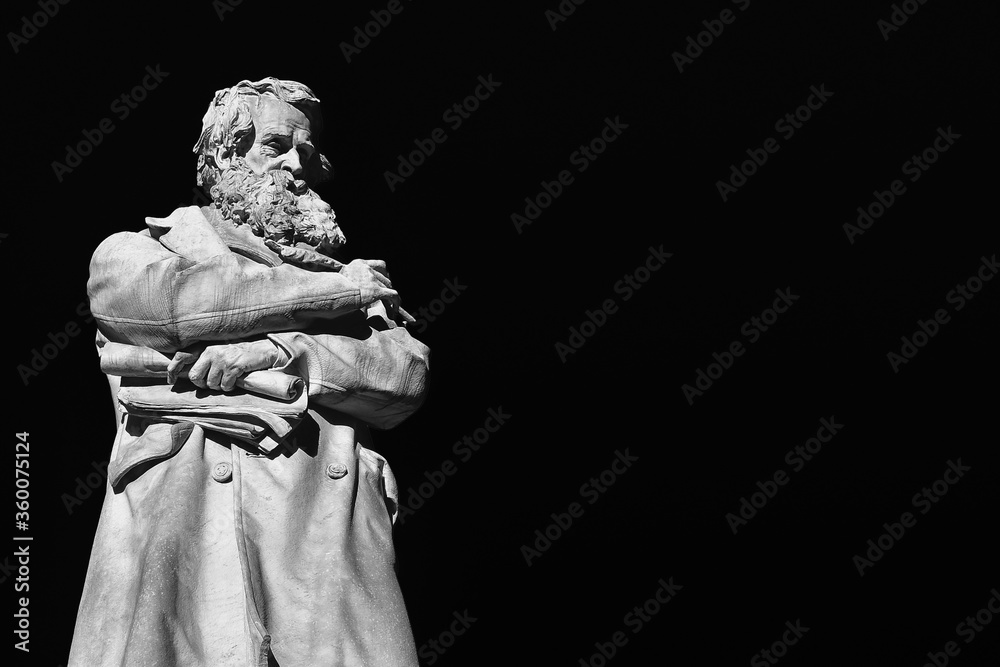 Intellectual and wise man. Marble statue of Niccolo Tommaseo erected in 1882 in the center of Venice Santo Stefano square (Black and White with copy space)