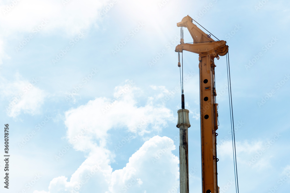 Close up of construction ้heavyequipment the crane of truck car piling rigs. under blur sky and white cloud. Close up of construction ้heavyequipment the crane of truck car piling rigs. under blur sky and white cloud.