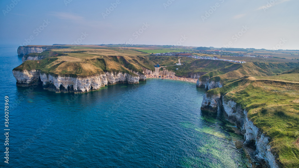 Aerial view of a stunning coastal bay surrounded by white cliffs