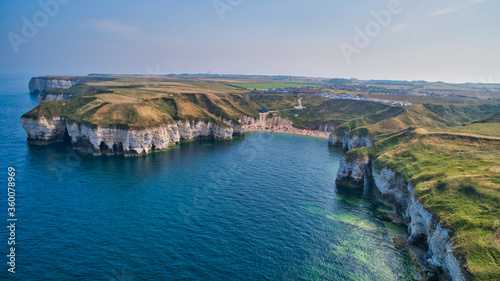 Aerial view of a stunning coastal bay surrounded by white cliffs
