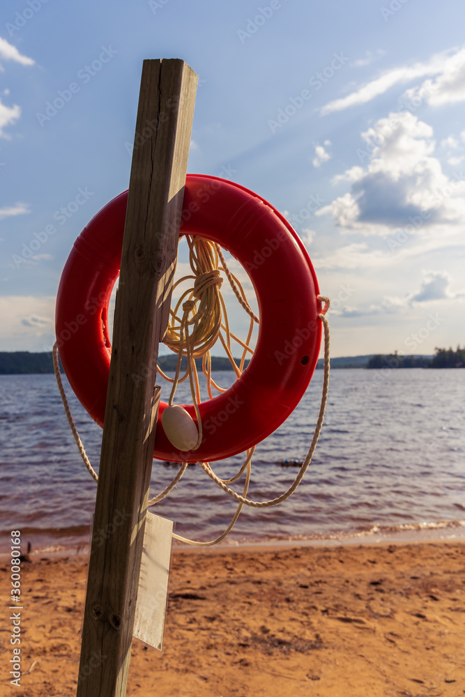 Lifesafer hanging on a Canadian Lake during sunset in summer