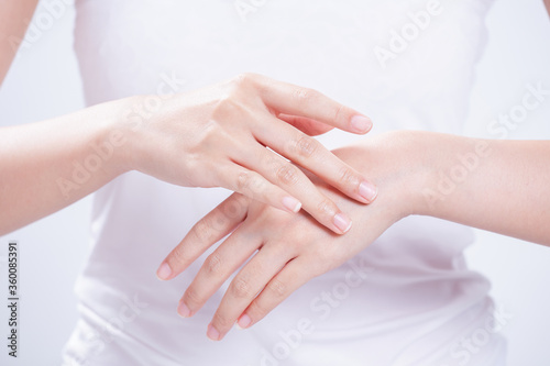 closeup of female hands applying hand cream Lotion