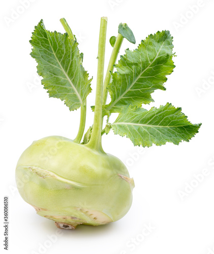 Green kohlrabi with green leaves on isolated white background.