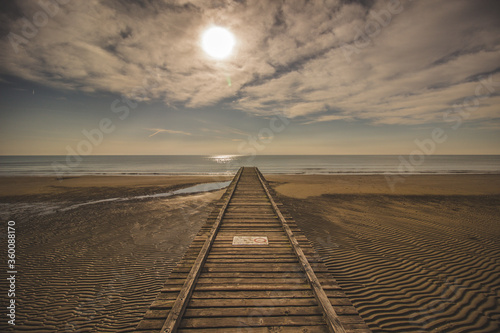 Wooden pier in the morning sun  beach of Lido Di Jesolo  Italy