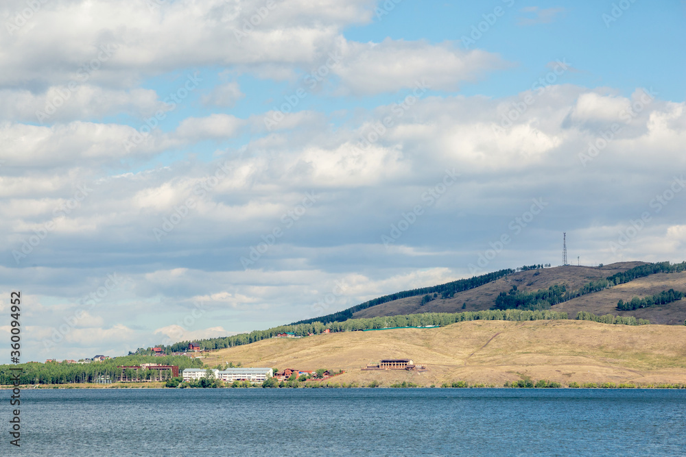 Lake among the Ural mountains, cloudy sky