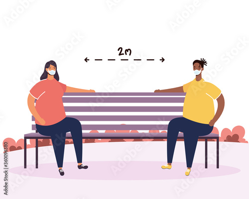 interracial couple practicing social distancing in park chair