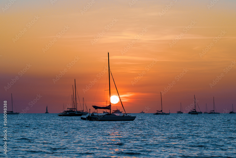 Sailing boats at Vesteys beach at sunset. Darwin, Northern Territory, Australia.