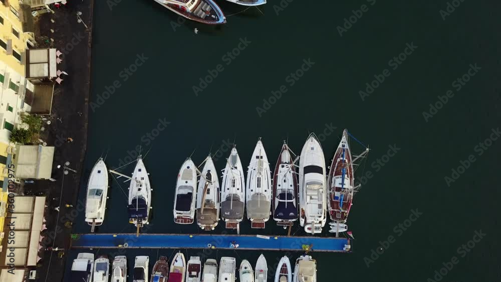 Aerial view of the harbour with yachts and buildings ashore in the small port of Ischia island. Aerial view of the harbour with yachts and buildings ashore in the small port of Ischia island.
