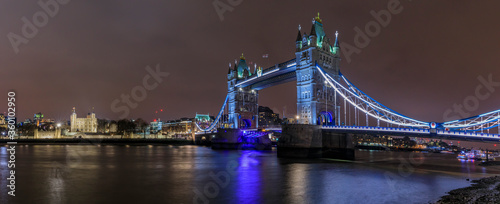 Panorama of city skyline at night with Tower Bridge and Tower of London in London England